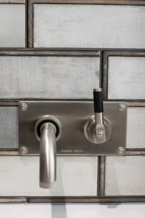 Shower controls with white industrial style tiles